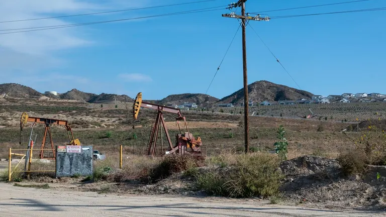 Oil pumpjacks in an open rural landscape
